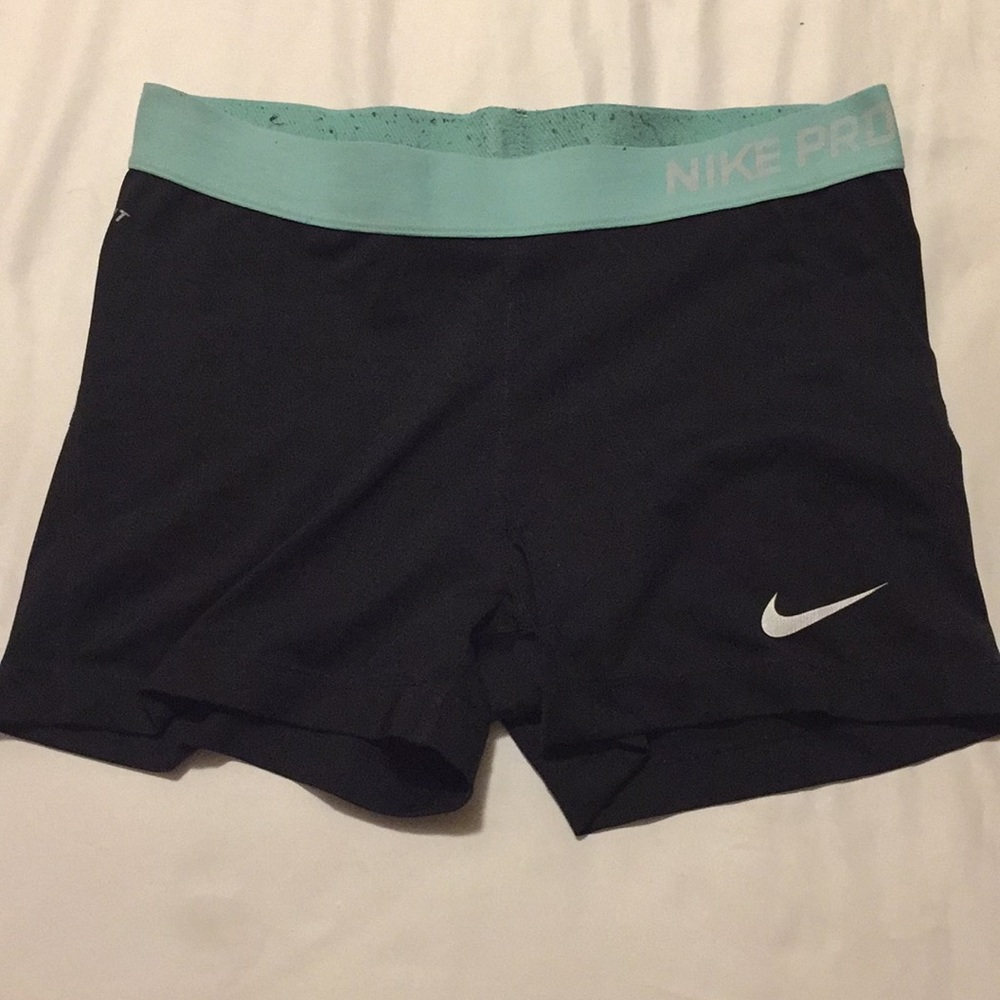 Black and mint green Nike compression shorts